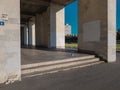 Entrance to the corridor from the arches of a light old geometric dirty building in a poor area